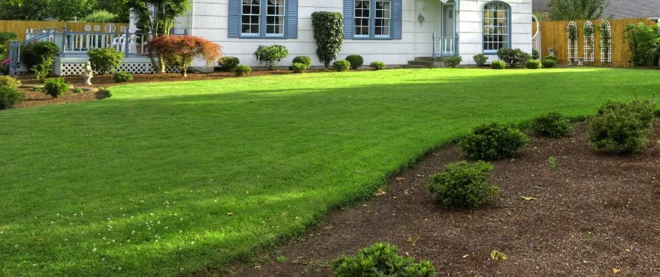 Mulched landscape by a green lawn in Fairless Hills, PA.