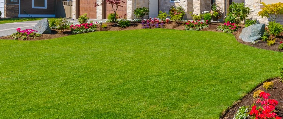 Vibrant flowers around a lush green lawn in Conshohocken, PA.