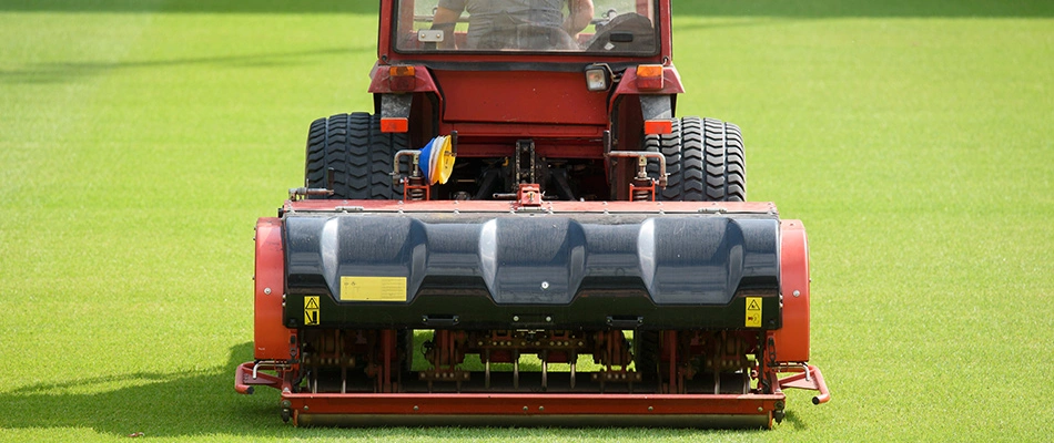 A professional lawn aeration process is underway on an sports field lawn near Doylestown, PA.